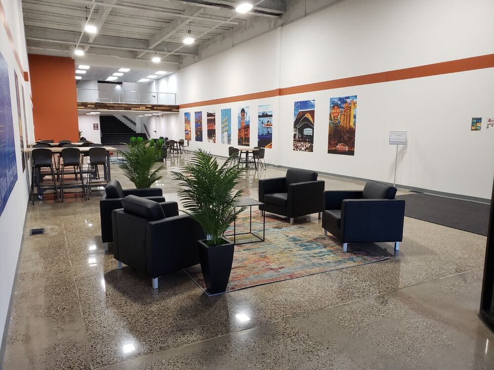 Lobby of an industrial building with lounge seating and Minneapolis posters