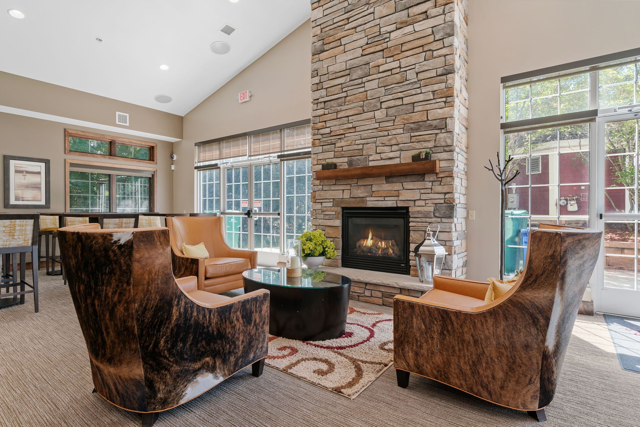 Clubhouse lounge with a stone fireplace at Bass Lake Hills