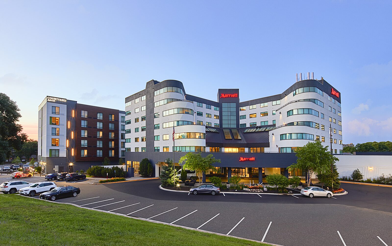 Minneapolis Marriott West hotel at dusk with a curved white facade